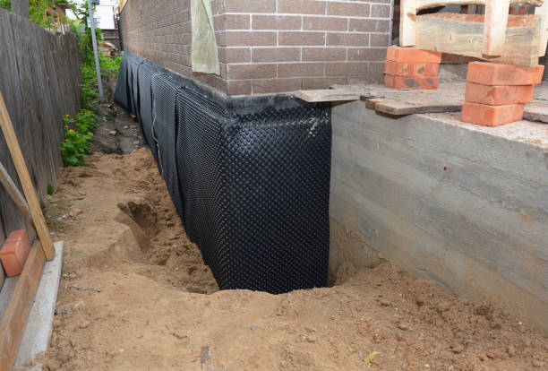 Happy homeowners after waterproofing job in Olivet